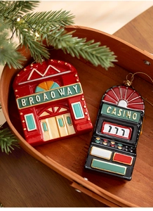 Detail of vintage Broadway and Casino ornaments in a wooden basket with pine branches