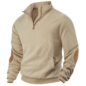 Men's beige quarter-zip sweatshirt with quilted grid texture and brown suede elbow patches