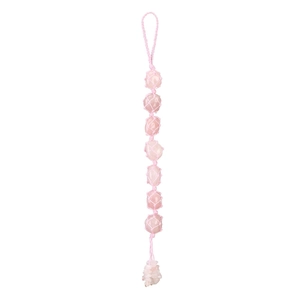 Detail of handmade rose quartz crystal wall hanging with pink woven net and tassel decor