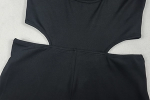 Detail of waist cutout design on a black stretch knit bodysuit with seamless edges