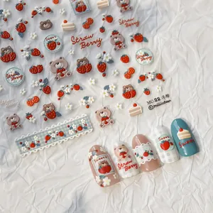 Macro detail of 3D embossed nail stickers featuring cute strawberry bear and dessert designs