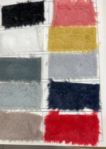 Macro display of faux fur fabric swatches in various colors for heart plush pillows