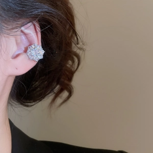 Detailed view of silver flower ear cuff with sparkling zircon crystals on model