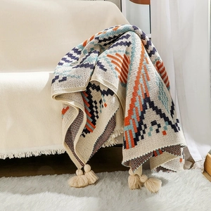 Thick knitted bohemian navajo throw blanket with geometric patterns and fringe tassels