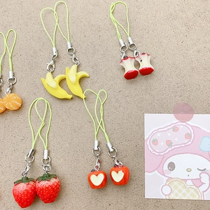 Macro shot of assorted resin fruit phone charms featuring orange, banana and strawberry