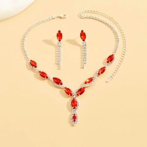 Detail of bridal jewelry set featuring red marquise rhinestones and silver tassels
