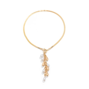 Detail of golden flat snake chain with teardrop charms and pearl tassel pendant
