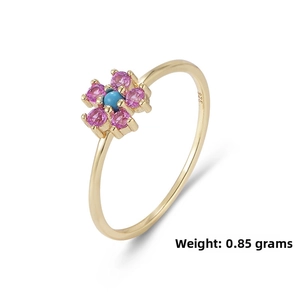 Macro detail of 925 sterling silver gold ring with flower inlay and gemstone
