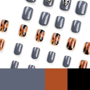 Press-on nail set with dark grey glossy finish and tortoise shell pattern fleur-de-lis
