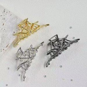 Gothic spider web hair claws in gold silver and grey metal finishes for Halloween