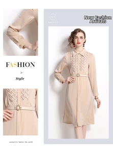 Detail of elegant champagne long-sleeve shirt dress featuring textured bodice and leather belt