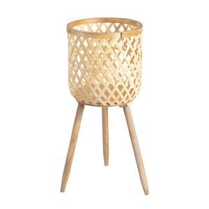 Large hand-woven bamboo planter with three solid wood legs on a white background