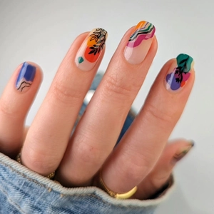 Abstract colorful press-on nails with botanical leaf patterns and a high gloss finish