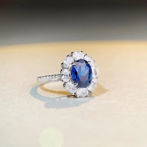Elegant S925 sterling silver ring featuring an oval blue gemstone with a diamond halo