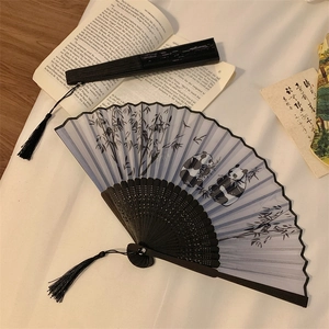 Classic Chinese folding fan featuring giant panda and bamboo design with silk tassel