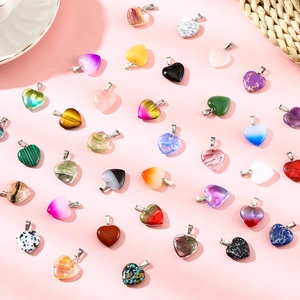 Flat lay macro of diverse colorful natural stone heart pendants with metal clasps