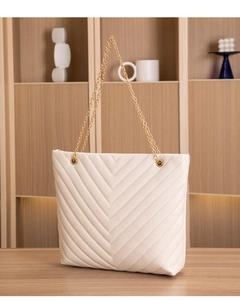Detail of off-white tote bag with V-quilted stitching and elegant gold chain strap
