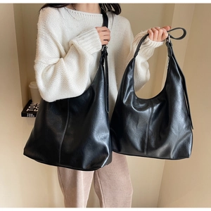 Detailed view of large black PU leather hobo bag with adjustable metal buckle strap