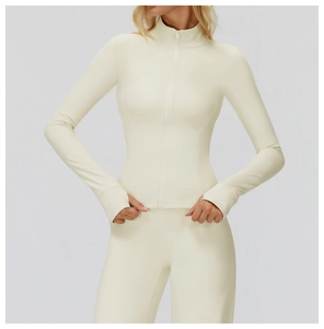 Detailed view of the thumb holes and high-stretch cuffs on the cream athletic jacket