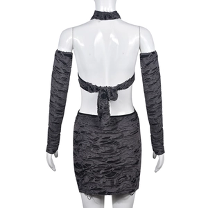 Detail of dark grey distressed three-piece set showing back view and hollow-out texture