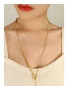 Detail of 18k gold plated OT buckle necklace with asymmetric snake and curb chain