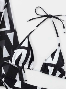 Detail view of the black and white geometric print on this three-piece bikini set