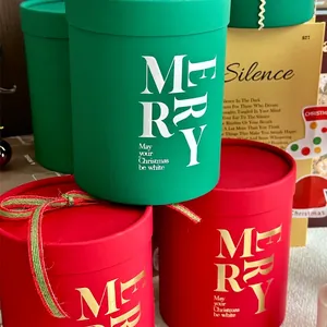 Set of three round Christmas gift boxes in red and green with gold Merry text and ribbons
