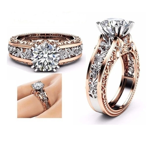 Detailed view of two-tone rose gold and silver ring with baroque floral engraving