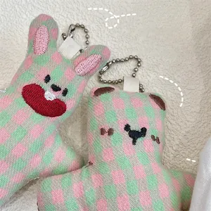 Detailed embroidery on checkered plush rabbit and bear charms with silver bead chains