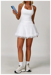 Close-up of white racerback sports tank top and layered pleated mesh skirt set for women