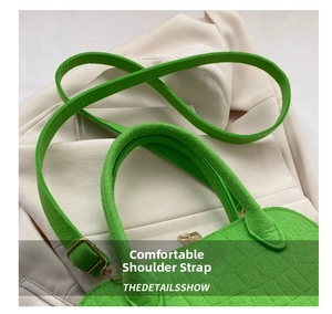 Macro detail of grass green felt shell bag with crocodile texture and gold metal buckle
