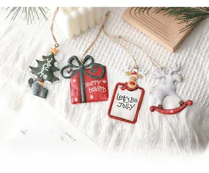 Detailed view of four Nordic metal Christmas ornaments with rustic rope hangers
