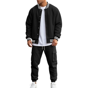 Close-up of black baseball jacket and cargo pants on male model in sporty style