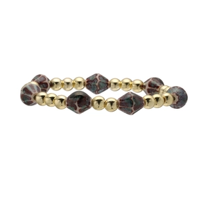 Rhombus ceramic beaded bracelet with golden beads and marble texture on white background