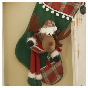 Close-up of green Christmas stocking featuring a 3D plush reindeer and plaid patterns