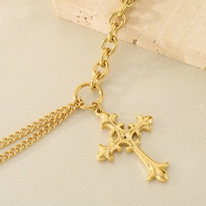 Close-up of golden stainless steel cross pendant necklace with OT buckle and double chains