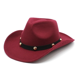 Detail of burgundy wool fedora featuring a black velvet band with gold metal studs