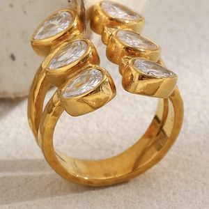 Close-up of double layer gold ring with six pear-cut cubic zirconia and hammered metal finish