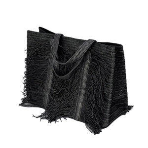 Handmade black woven straw tote bag with long tassels for beach vacations and daily use
