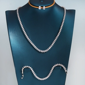 Detailed view of silver necklace and earrings set with sparkling pear-cut zircon crystals