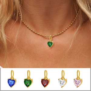 Detailed view of heart-shaped zircon pendants in five vibrant colors on golden bases