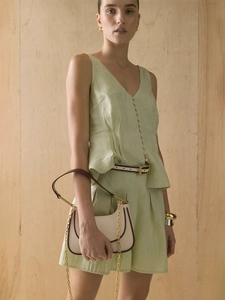 Detailed texture of pleated cotton vest and high waist A-line shorts with buttons