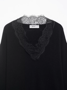 Close-up of elegant V-neckline with black floral lace splicing and eyelash lace trim