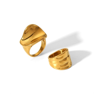 Detailed close-up of 18k gold-plated stainless steel rings with smooth and wavy textures
