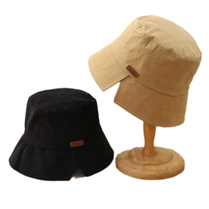 Canvas bucket hats in black and khaki featuring side slits and leather brand tags