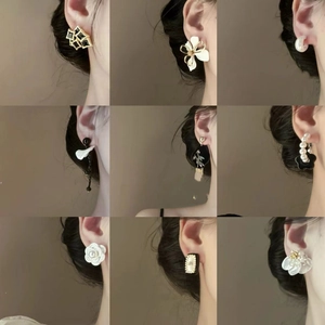 Collection of nine geometric zircon bow and pearl earrings in elegant gold finishes