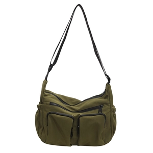 Army green multi-zipper nylon crossbody bag with adjustable black strap on white background