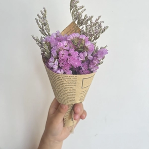 Mini purple dried flower bouquet wrapped in vintage newspaper with jute twine