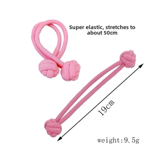 Pink elastic hair tie showing high-stretch feature up to 50cm with spherical knots