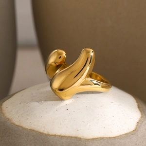Close-up of polished 18k gold plated stainless steel ring with abstract geometric design